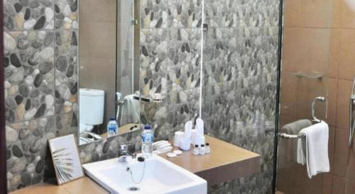 a bathroom with a sink and a shower at VillaTel Salse in Bandung