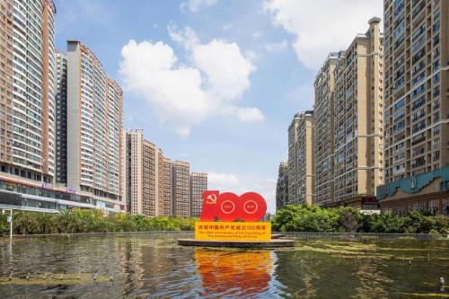 a sign in the middle of a city with tall buildings at Fortune International Hotel in Xiawutun