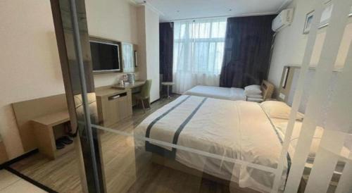 a hotel room with a bed and a television at City Comfort Inn Dangtu High Speed East Railway Station RT-Mart in Ma'anshan