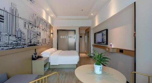 a hotel room with a white bed and a table at City Comfort Inn Nanning Railway Station Guangxi University in Nanning