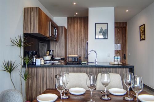 a dining room table with wine glasses on it at Luxurious 2BR apartment with Jacuzzi and Awesome Views in Mexico City