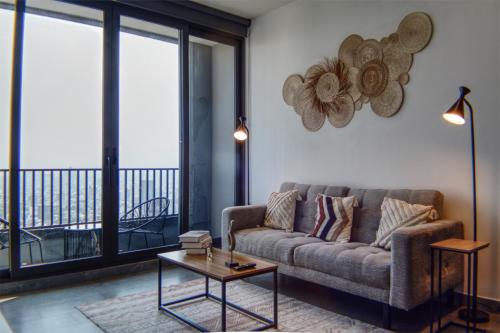 a living room with a couch and a table at Luxurious 2BR apartment with Jacuzzi and Awesome Views in Mexico City