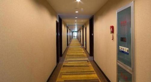 a long hallway with wooden floors in a building at Huangshan International Hotel in Huangshan