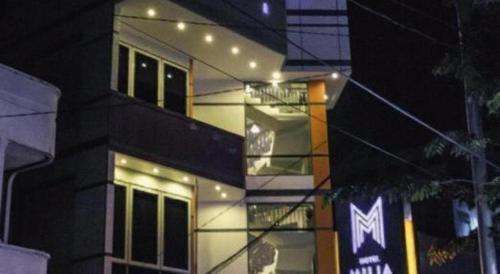a tall building with lights on it at night at Hotel D' CaLia Tarakan in Tarakan
