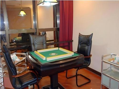 a room with a table and two chairs at Out Sky Hotel in Huizhou