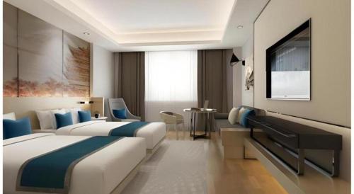 a hotel room with two beds and a television at Jinjiang Metropolo Hotel Nanjing Confucius Temple Branch in Nanjing