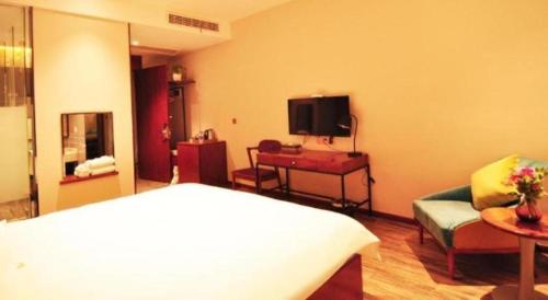 a hotel room with a bed and a television at Hangzhou Berman Hotel in Hangzhou