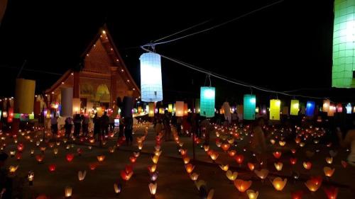 a group of people standing in front of a building with umbrellas at The View Pavilion Hotel in Luang Prabang