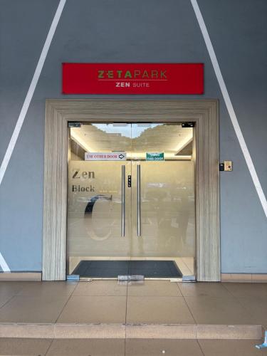 a glass door of a building with a sign on it at Ubays Zetepark House in Kuala Lumpur