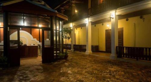 an empty courtyard of a building at night at The View Pavilion Hotel in Luang Prabang