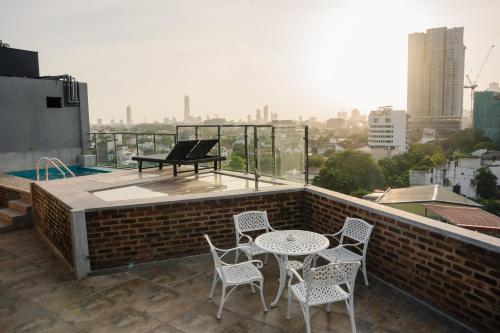 a patio with a table and chairs on a roof at Trillium Boutique Express Hotel - Ward Place in Colombo