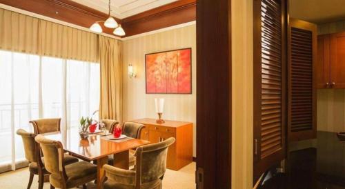 a living room with a dining room table and chairs at Labersa Grand Hotel &Convention Center in Pekanbaru