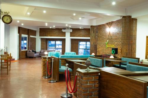 a lobby with blue chairs and tables in a building at Trillium Boutique Express Hotel - Ward Place in Colombo