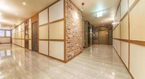 a hallway of a building with a brick wall at H Hotel in Ulsan
