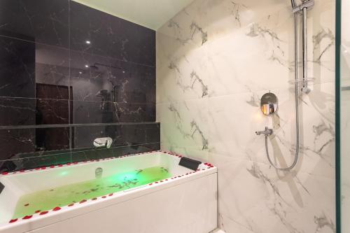 a bathroom with a tub and a shower at Hotel Sara Sadan in Kathmandu