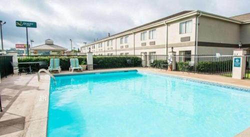 a large swimming pool in front of a hotel at Quality Inn Prattville I-65 in Prattville