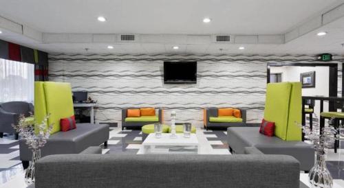 a living room with two couches and a tv at Quality Inn Prattville I-65 in Prattville