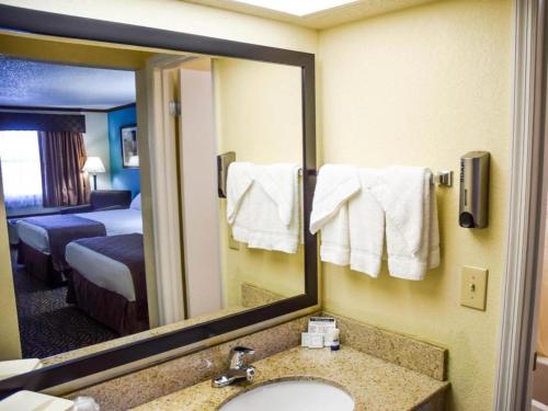 a hotel room with a bathroom with a sink and a mirror at Best Western Fairwinds Inn in Cullman