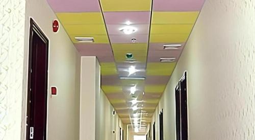 a hallway with colorful ceilings in a building at Sheng Lin Na Hotel Minzhi Branch in Shenzhen