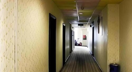 a hallway of an office building with a long corridor at Sheng Lin Na Hotel Minzhi Branch in Shenzhen