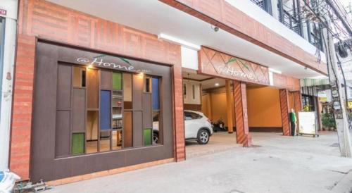a store front of a building with a car in it at At Home at Udon in Udon Thani