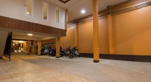 a garage with motorcycles parked inside of a building at At Home at Udon in Udon Thani