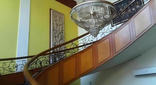 a spiral staircase with a large glass ball on it at Larisae Setia Kawan Hotel in Solo