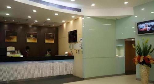 a lobby with a reception desk and a counter at West Hotel in Hong Kong