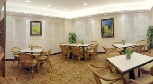 a restaurant with tables and chairs in a room at West Hotel in Hong Kong