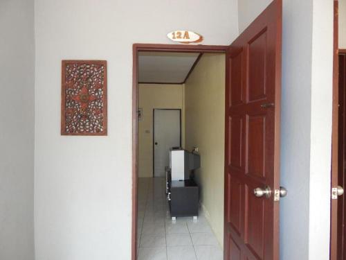 a hallway with a door leading to a room at Jinta Hotel Nathon Beach in Chaweng