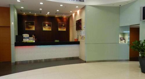 a fast food restaurant with a counter in a building at West Hotel in Hong Kong