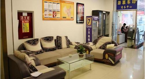 a living room with a couch and a table at 7 Days Inn Chengdu Huayang Metro Station Binfen Plaza in Chengdu