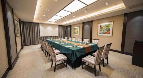 a large conference room with a long table and chairs at Jin Jiang Nanjing Hotel in Nanjing