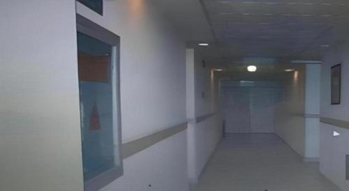 an empty hallway in a building with a door at Jinjiang Inn Wuhu High-Speed Railway Station West Square in Wuhu