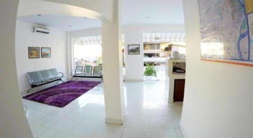 a living room with a purple rug on the floor at Hotel Zing Phnom Penh in Phnom Penh