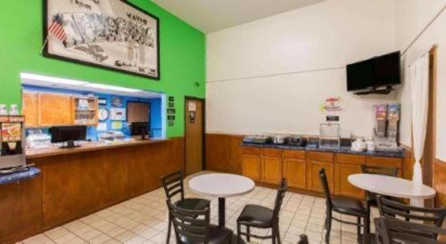 a fast food restaurant with two tables and chairs at Super 8 By Wyndham Wayne in Wayne