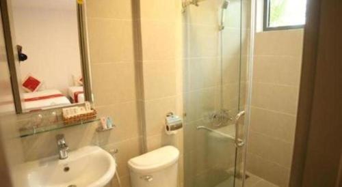 a bathroom with a shower and a toilet and a sink at Green Hotel Da Nang in Da Nang