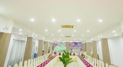 a large room with a row of chairs and a room with at Green Hotel Da Nang in Da Nang