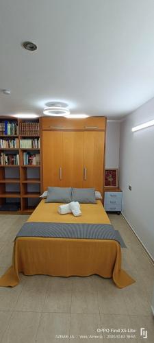 a bedroom with a large bed with two towels on it at Suite solarium Km21 in Vera