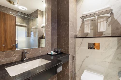 a bathroom with a sink and a mirror at Hotel Sara Sadan in Kathmandu