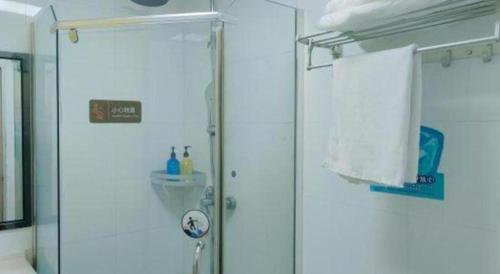 a bathroom with a shower and a glass door at 7 Days Premium·Xiamen Airport Xianglu in Xiamen