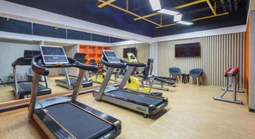 a gym with several exercise bikes in a room at Atour Hotel Weihai Shidao in Dongshan