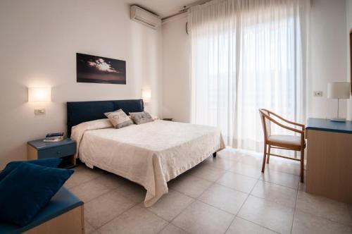 Postel nebo postele na pokoji v ubytování Residence La Rosa di Nettuno