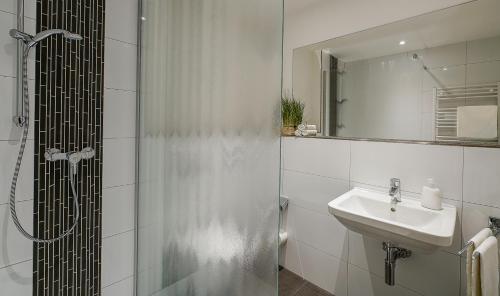 a bathroom with a shower and a sink at Chrisma in Düsseldorf
