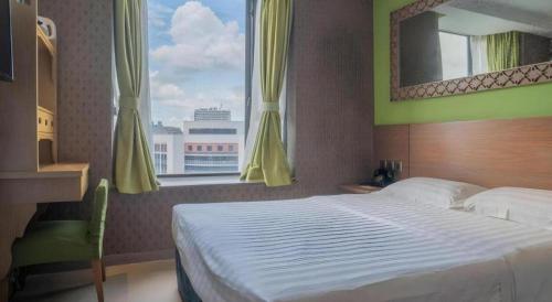 a bedroom with a large bed and a window at Largos Hotel in Hong Kong