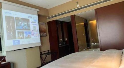 a projection screen in a room with a bed at The Qube Shanghai Nanqiao in Shanghai