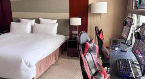a hotel room with a bed and a desk at The Qube Shanghai Nanqiao in Shanghai