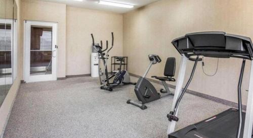 a gym with two exercise bikes in a room at Rodeway Inn & Suites Salina South in Salina