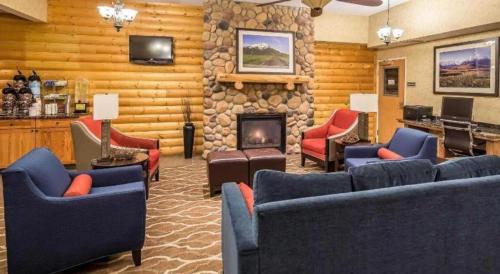 a living room with couches and a stone fireplace at Sleep Inn Bessemer Helena in Bessemer