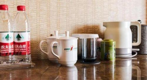 a counter top with coffee makers and a blender at Hangzhou The First World Hotel in Hangzhou